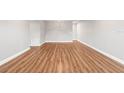 Spacious living room featuring wood-look floors and neutral gray walls at 2041 Australia W Way # 35, Clearwater, FL 33763