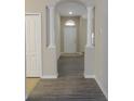 Inviting foyer with decorative columns, light walls and new flooring at 3147 Sunwatch Dr, Wesley Chapel, FL 33544