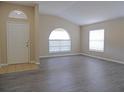 Spacious living room featuring new floors and a large window for natural light at 3147 Sunwatch Dr, Wesley Chapel, FL 33544