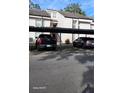 Exterior of covered parking spots with multiple vehicles and a staircase at 5162 Puritan Cir # 5162, Tampa, FL 33617