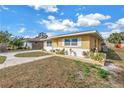 Well-maintained single-story home with a tidy lawn, fresh landscaping, and painted white brick base at 6537 8Th N Ave, St Petersburg, FL 33710