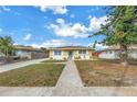 Cozy single-Gathering home with a tidy front lawn, complemented by a bright exterior paint scheme at 6537 8Th N Ave, St Petersburg, FL 33710