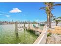 Waterfront dock with boat lift on a sunny day, offering direct access to the water at 7984 1St S Ave, St Petersburg, FL 33707