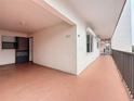 This is a ground level exterior view of the condominium hallway, and exterior door, including the building's architecture at 8174 Terrace Garden N Dr # 307, St Petersburg, FL 33709