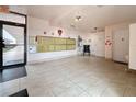 A well lit indoor entryway features tiled floors and a glass exit door, showcasing a bright and welcoming lobby at 8174 Terrace Garden N Dr # 307, St Petersburg, FL 33709