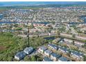 Waterfront homes are shown in an aerial view, with access to canals and a lush green backdrop at 9705 Bay Grove Ln, Tampa, FL 33615