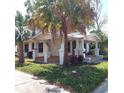 Inviting two-story home with a classic porch, a well-manicured lawn, and classic architectural style at 1001 W Baker St, Plant City, FL 33563