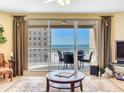 Comfortable living room with a sliding glass door to a balcony with ocean views at 11 San Marco St # 807, Clearwater Beach, FL 33767
