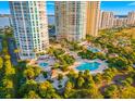 Aerial view showcasing stunning condo buildings with access to multiple pools, lush landscaping, and serene waterfront views at 1170 Gulf Blvd # 2001, Clearwater, FL 33767