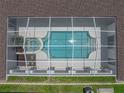 Overhead view of a screened pool with an attached jacuzzi, providing a private outdoor retreat at 12333 Woodlands Cir, Dade City, FL 33525