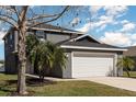 Two-story home featuring a two-car garage and beautifully landscaped front yard at 1308 22Nd E St, Palmetto, FL 34221