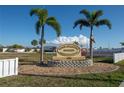 Four Seasons Estates sign with lush landscaping and bright blue skies. Resident Owned Community at 13225 101St St # 462, Largo, FL 33773