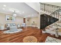 Elegant foyer featuring hardwood floors, a compass rose inlay, and a staircase at 1336 51St Ne Ave, St Petersburg, FL 33703