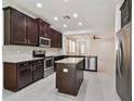 Spacious kitchen with stainless steel appliances, granite countertops, island, and open floor plan at 17596 Terrazzo Way, Land O Lakes, FL 34638