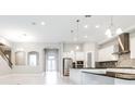 Open-concept living room and kitchen with stainless steel appliances, granite counters and island at 21807 Amelia Rose Way, Land O Lakes, FL 34637