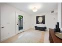 Clean, bright foyer with modern decor, neutral rug, and outdoor views at 3010 W Stovall St # B, Tampa, FL 33629