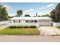 Charming single-story home features a well-manicured lawn, white fence, and a two-car garage, enhancing its curb appeal at 4726 Lansing Ne St, St Petersburg, FL 33703