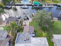 Aerial view of waterfront property with boat dock, rooftop patio, and lush landscaping at 5033 Blue Heron Dr, New Port Richey, FL 34652