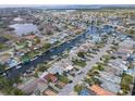 Aerial view of canal front neighborhood with waterfront homes and private boat docks at 5033 Blue Heron Dr, New Port Richey, FL 34652