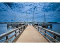 Picturesque waterfront view from the private boat dock with boats sailing on the horizon under a cloudy sky at 5200 Brittany S Dr # 902, St Petersburg, FL 33715