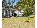 Spacious carport of a two-story home with a well-maintained lawn at 602 Nw Drane St, Plant City, FL 33563