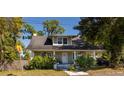 Inviting two-story home featuring a classic design and a welcoming front porch at 602 Nw Drane St, Plant City, FL 33563