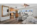 Open-concept living area with lots of seating, dining area and a modern ceiling fan at 661 Poinsettia Ave # 307, Clearwater Beach, FL 33767
