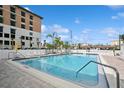 Community pool featuring white lounge chairs and view of the ocean at 661 Poinsettia Ave # 307, Clearwater Beach, FL 33767
