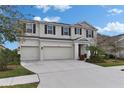 Charming two-story home with a three-car garage and a well-maintained front yard at 7528 Paradiso Dr, Apollo Beach, FL 33572