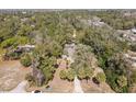 Aerial view of a secluded home nestled among lush trees, offering privacy and tranquility at 9641 Fulton Ave, Hudson, FL 34667