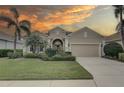 Beautiful home with a landscaped front yard, palm trees, and a warm, inviting curb appeal at 11610 Griffith Park Ter, Bradenton, FL 34211