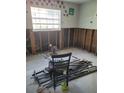 Bedroom renovation project shows studs, items on the floor, and window light at 200 Country Club Dr # 903, Largo, FL 33771