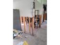 Home renovation project shows studs, bare concrete floor, and staging items at 200 Country Club Dr # 903, Largo, FL 33771