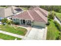 Inviting exterior showcasing lush green lawn, beautiful landscaping, and a spacious driveway to a two car garage at 25950 Risen Star Dr, Wesley Chapel, FL 33544