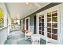 Spacious porch with comfortable seating, ceiling fan, and tiled flooring, ideal for relaxation at 3115 W Fair Oaks Ave, Tampa, FL 33611