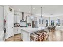 Bright, modern kitchen featuring a large island with seating, stainless steel appliances, and modern lighting at 5317 Del Coronado Dr, Apollo Beach, FL 33572