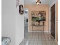 Welcoming foyer with tile flooring, decorative accents, and a view of the laundry room at 5357 Kirkwood Ave, Spring Hill, FL 34608