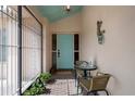 Inviting front porch with a seating area and vibrant blue door, perfect for enjoying the outdoors at 5357 Kirkwood Ave, Spring Hill, FL 34608