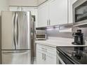 Well-equipped kitchen boasting stainless steel appliances and ample counter space at 6916 Stonesthrow N Cir # 9103, St Petersburg, FL 33710