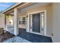 Inviting front entrance with stylish front door and covered porch at 814 15Th Ne St, Ruskin, FL 33570