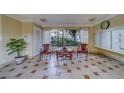 Sitting area in the lobby with table, chairs, neutral color palette, tiled floors, window, and a wall of mailboxes at 2612 Pearce Dr # 310, Clearwater, FL 33764