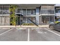 Exterior view of a two-story condo building with stairs and a parking lot at 3711 W Iowa Ave # 214, Tampa, FL 33611