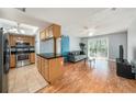 Cozy living room showcasing an open layout, a modern kitchen, and sliding glass doors to the outside at 3711 W Iowa Ave # 214, Tampa, FL 33611