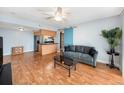 Bright living room featuring modern furnishings, wood floors, and a view of the kitchen area at 3711 W Iowa Ave # 214, Tampa, FL 33611
