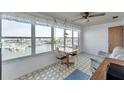 Bright dining area with water view through large windows, perfect for enjoying meals with a scenic backdrop at 5925 Shore S Blvd # 406, Gulfport, FL 33707