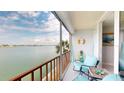 Inviting condo balcony with seating and beautiful views of the bay at 7910 Sun Island S Dr # 305, South Pasadena, FL 33707
