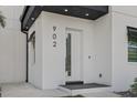 Close up of modern front door and a visible house number at 902 W Sligh Ave, Tampa, FL 33604