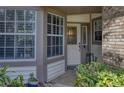 Inviting entryway with a decorative glass door, large windows, and lush landscaping at 1290 Clays Trl, Oldsmar, FL 34677