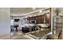 Kitchen showcasing granite countertops, stainless steel appliances, and dark wood cabinetry at 1290 Clays Trl, Oldsmar, FL 34677