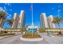 Ultimar residence entrance features manicured landscaping, palm trees, and a security gate for the high rise at 1520 Gulf Blvd # Ph1 1901, Clearwater Beach, FL 33767